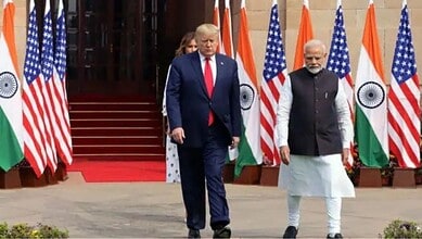 Leaders of India and the US walking past flags during diplomatic discussions.