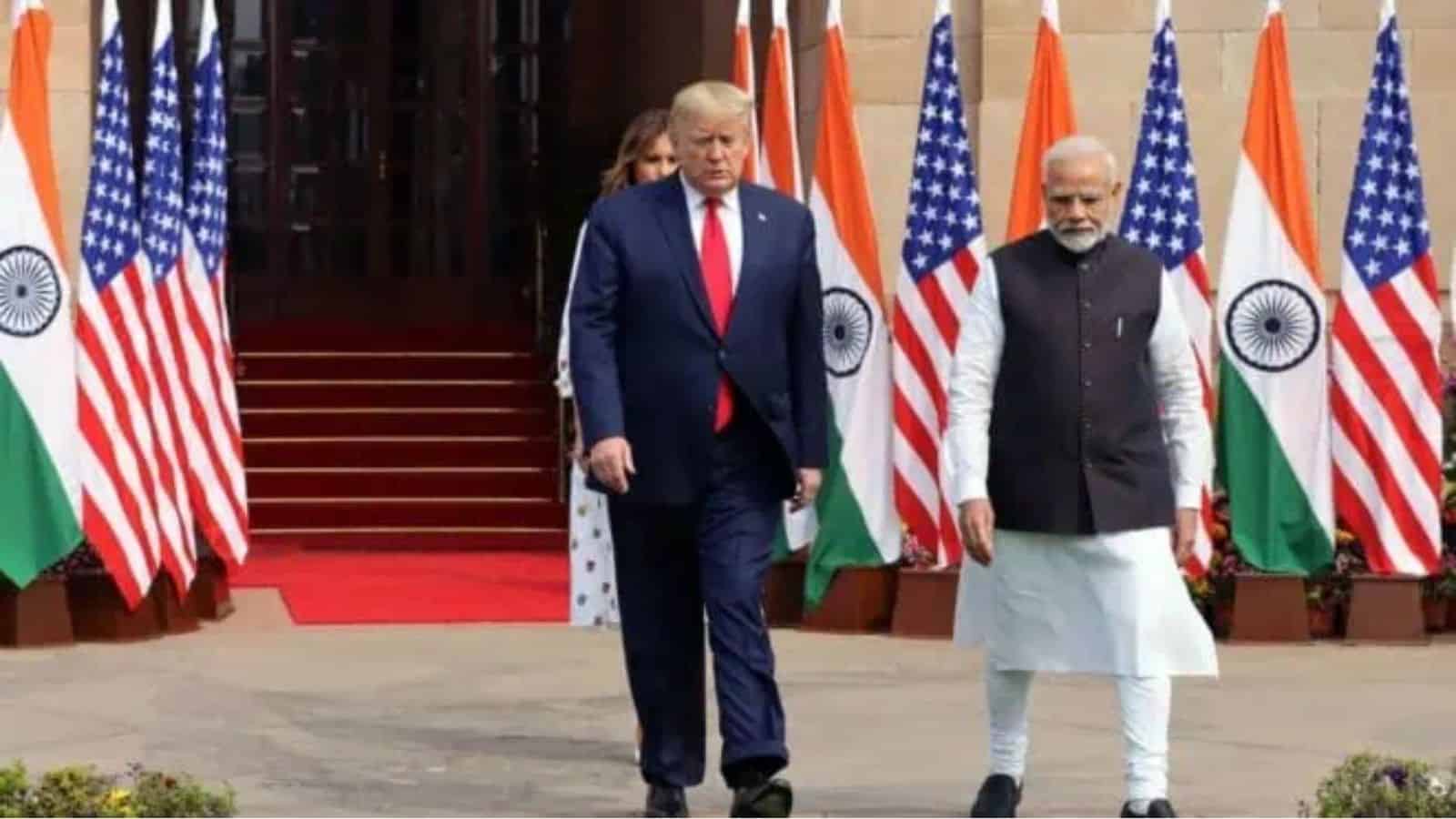 Leaders of India and the US walking past flags during diplomatic discussions.