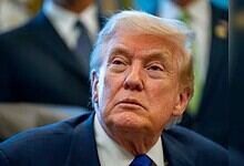 Donald Trump attending a political event, focused expression.