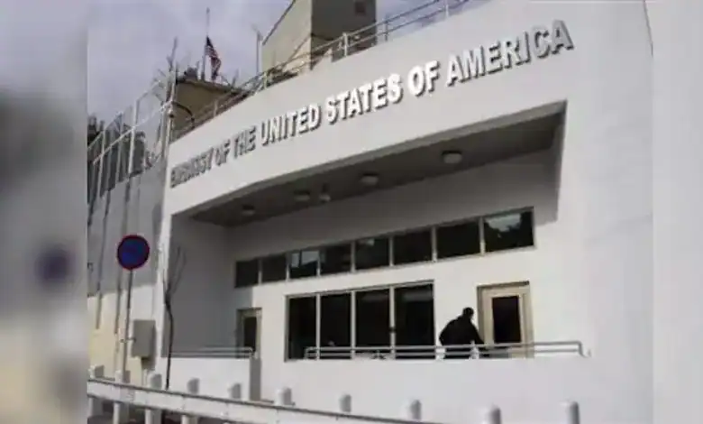 US Embassy in Syria building with American flag and signage.