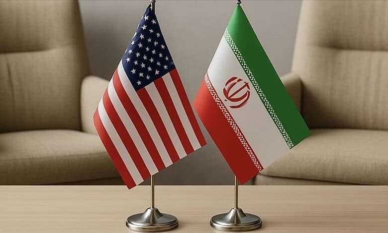 Flags of the United States and Iran placed side by side during a meeting.