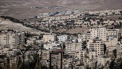 View of a densely populated Israeli settlement in the West Bank with residential buildings and surroundin.