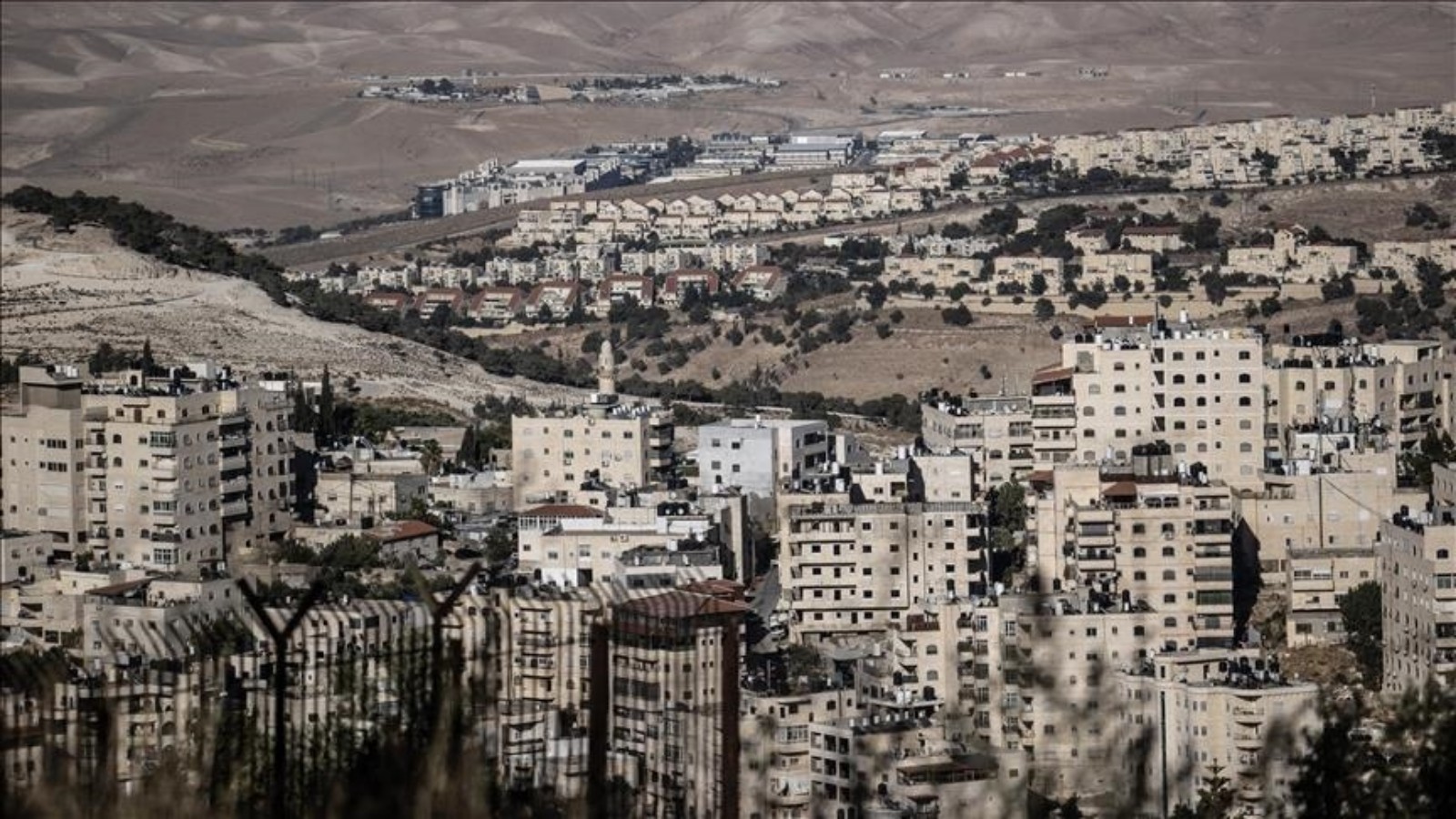View of a densely populated Israeli settlement in the West Bank with residential buildings and surroundin.