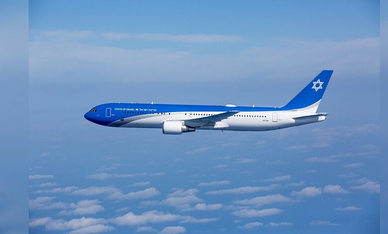 Israeli Boeing 737 plane flying above clouds with Star of David on tail.
