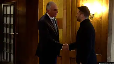 Ukrainian President Volodymyr Zelenskyy shakes hands with Iranian opposition leader Reza Pahlavi during a meeting in Munich.