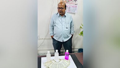 Hyderabad GHMC official with cash and bottles, arrested for demanding Rs 40K bribe.