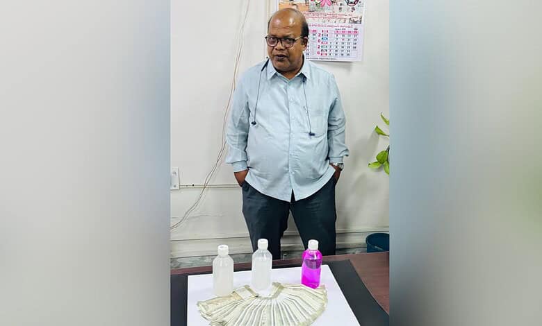 Hyderabad GHMC official with cash and bottles, arrested for demanding Rs 40K bribe.