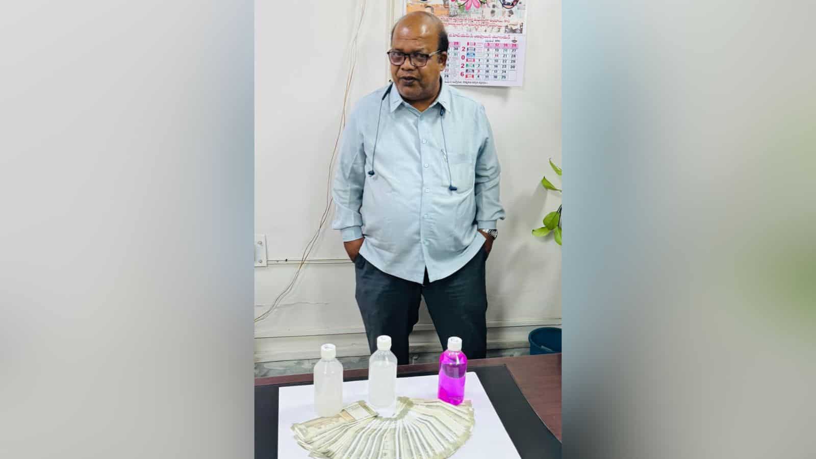 Hyderabad GHMC official with cash and bottles, arrested for demanding Rs 40K bribe.
