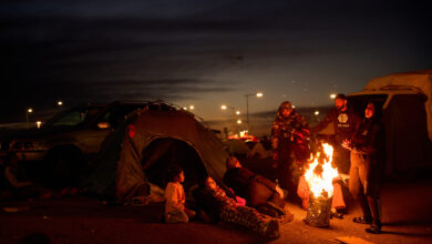 Members of a family, who fled Israeli strikes in southern Lebanon, sit around a bonfire outside a tent used as a shelter in Beirut, Lebanon, Wednesday, March 25, 2026. AP/PTI(AP03_26_2026_000313B)
