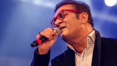 Abhijeet Bhattacharya singing passionately at a concert, seeking government assistance for his stranded s.