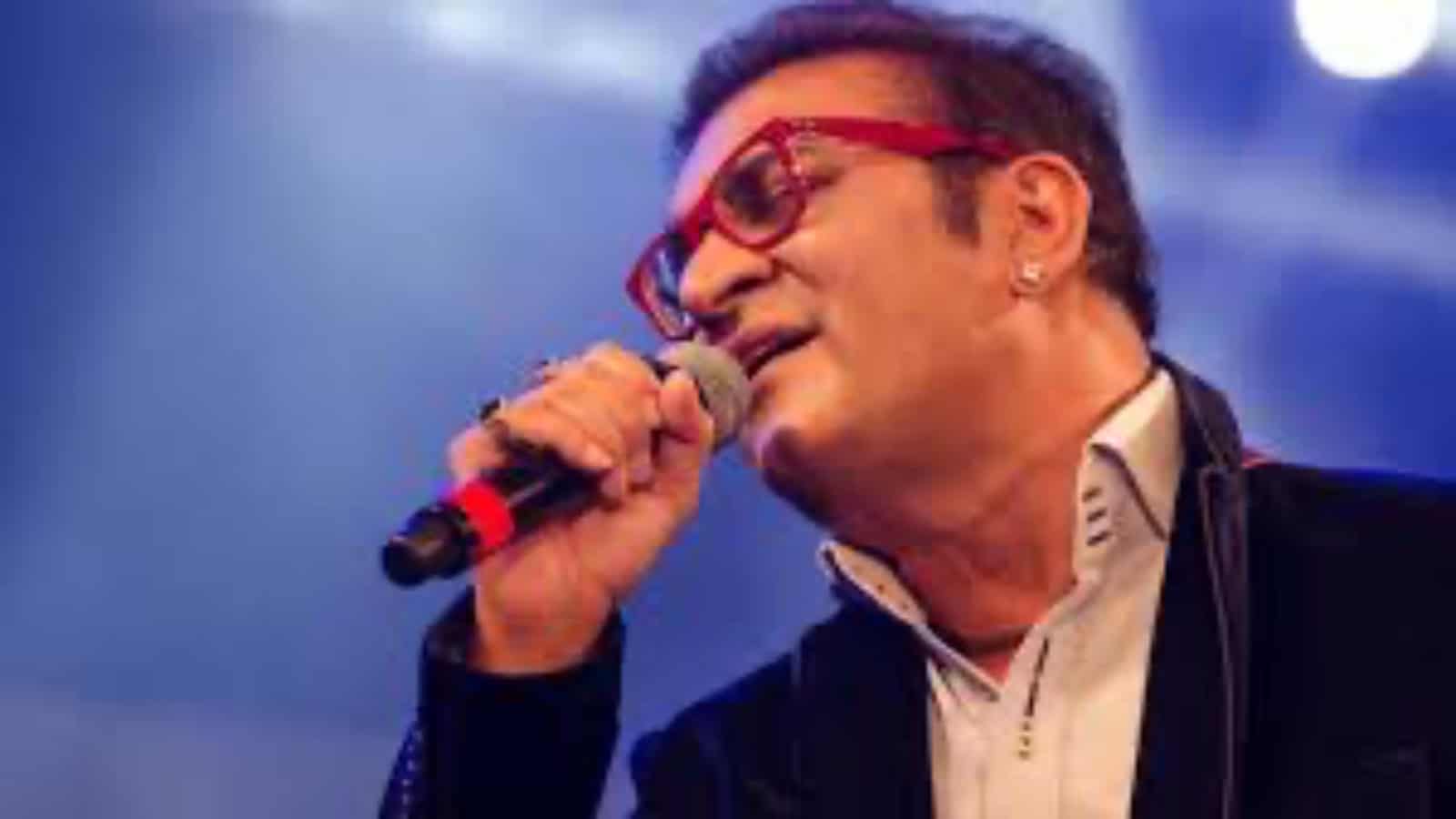 Abhijeet Bhattacharya singing passionately at a concert, seeking government assistance for his stranded s.