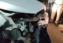 Damaged white car after collision with divider in Hyderabad's Bahadurpura, injuring four.
