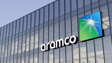 Modern Aramco office building with glass facade and company logo in Saudi Arabia.