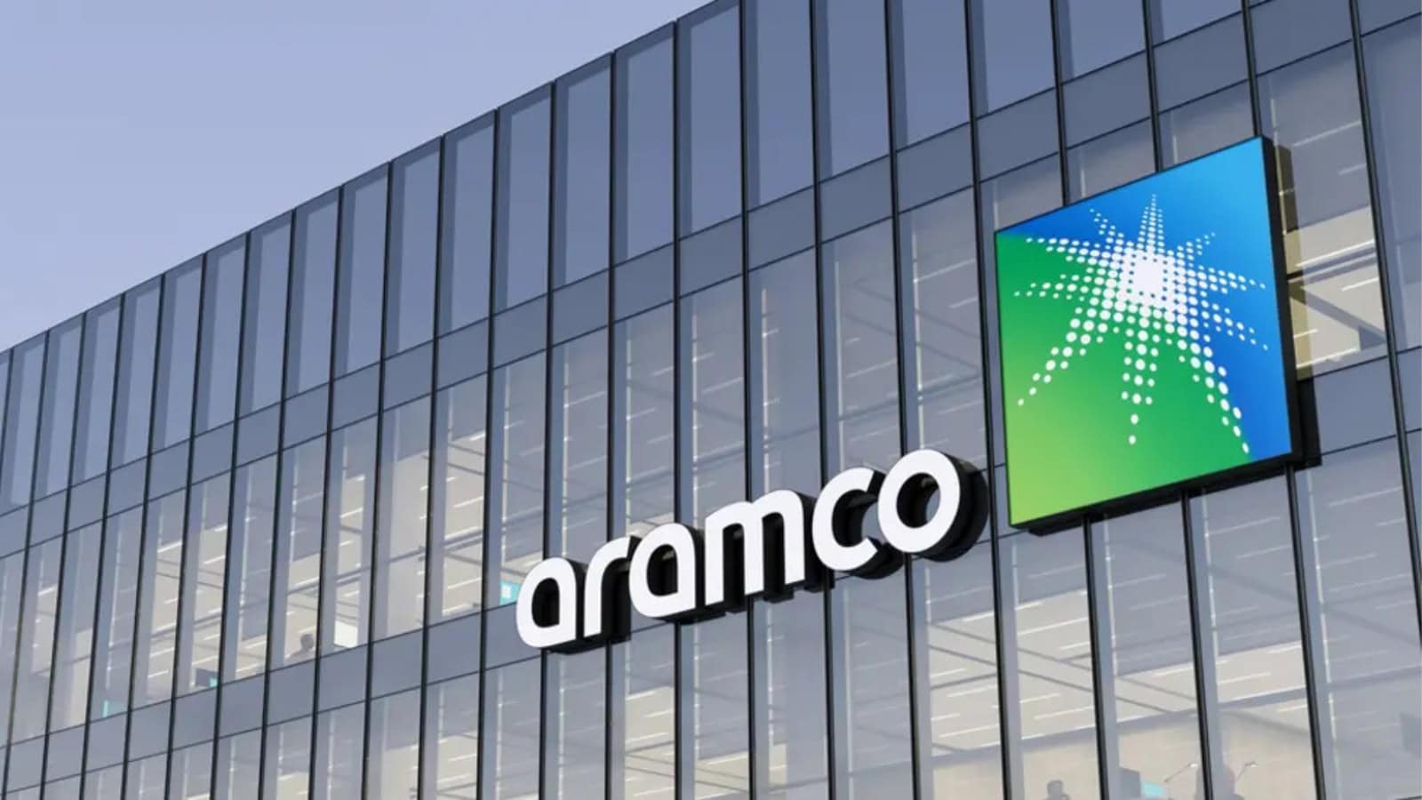 Modern Aramco office building with glass facade and company logo in Saudi Arabia.