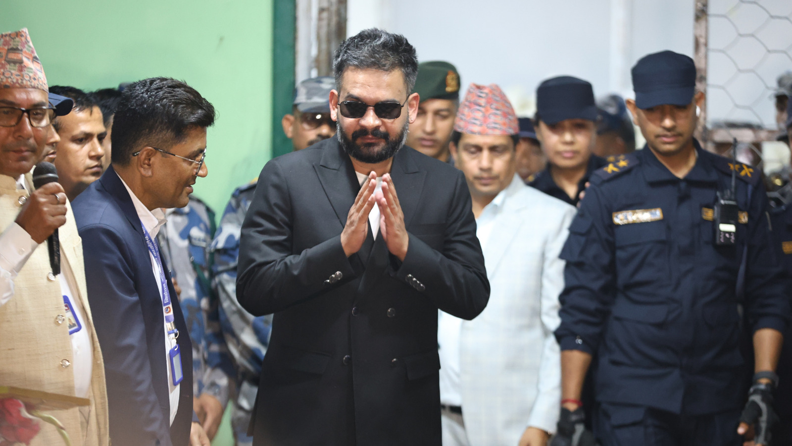 Balendra Shah, foreground, former mayor of Kathmandu Metropolitan City and prime ministerial candidate of the Rastriya Swatantra Party, arrives to receive his victory certificate