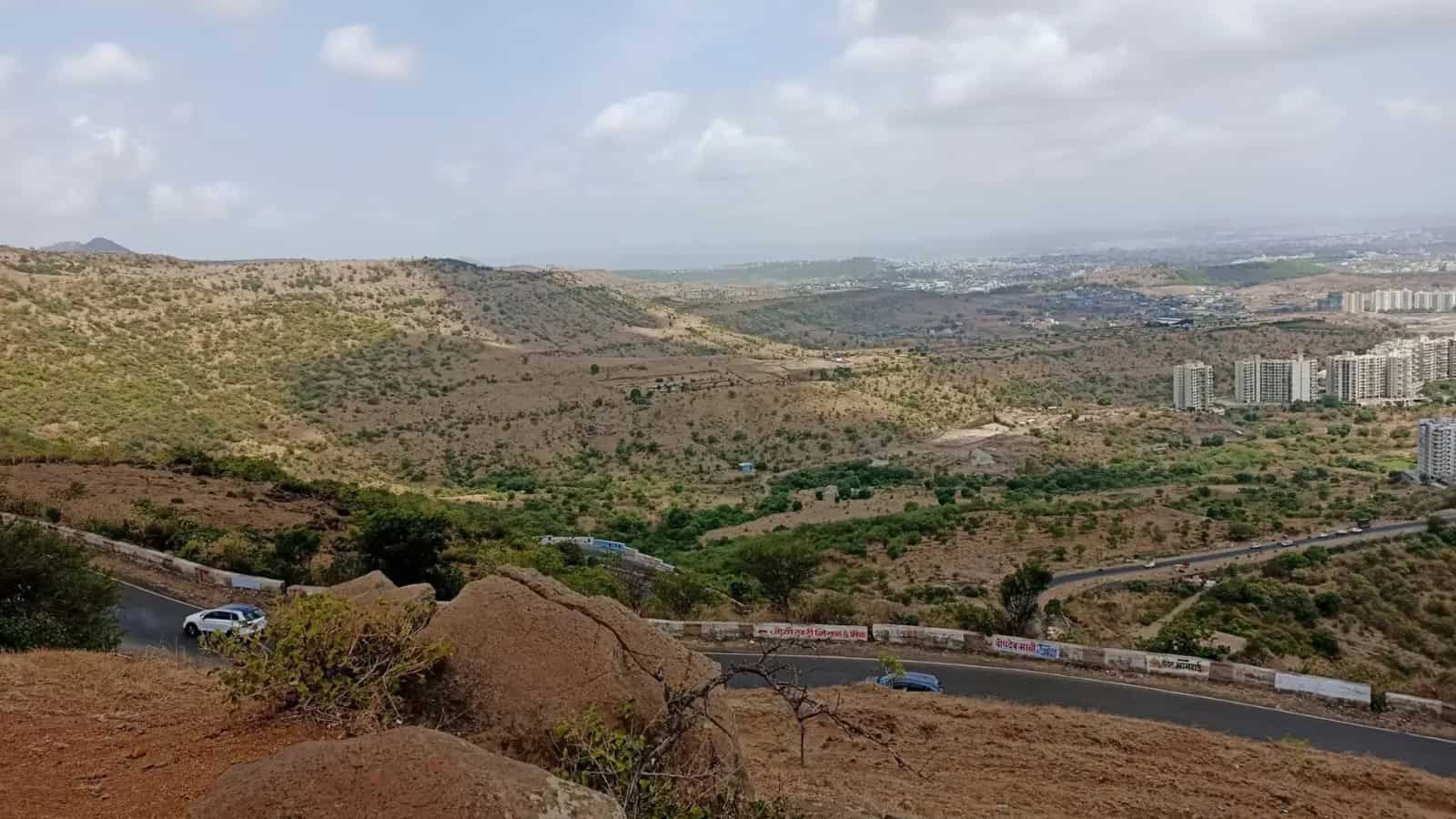 Panoramic view of hills and cityscape near Pune, India, during Ramzan with clear skies.
