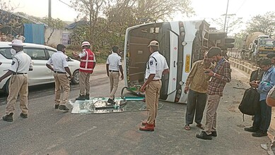 Bus carrying pharma employees overturns on Hyderabad road, causing injuries.