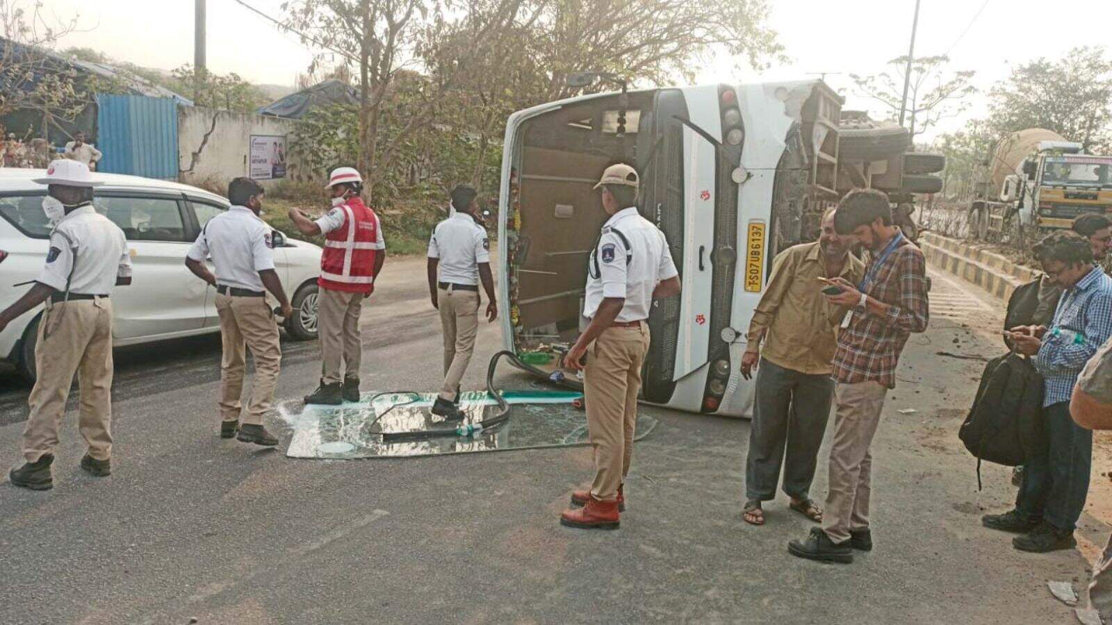 Bus carrying pharma employees overturns on Hyderabad road, causing injuries.