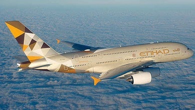 Etihad Airways Boeing 777 aircraft flying above clouds, promoting travel safety and comfort.