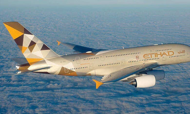 Etihad Airways Boeing 777 aircraft flying above clouds, promoting travel safety and comfort.