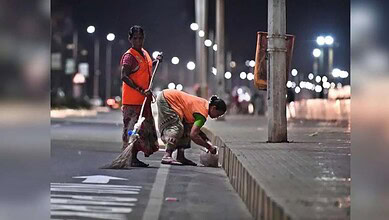 Group-I trainees cleaning streets during early morning sanitation in Hyderabad.
