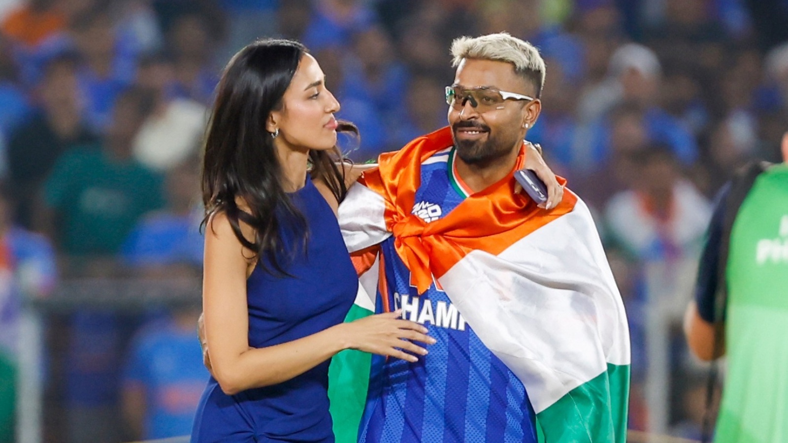 Hardik Pandya and Mahieka together at cricket match, discussing amidst crowd.