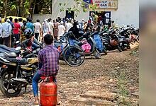 People waiting in line for LPG cylinders during fuel shortage.