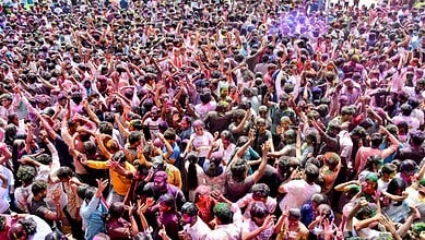 People celebrating Holi in Telangana with colourful powders and festive spirit.