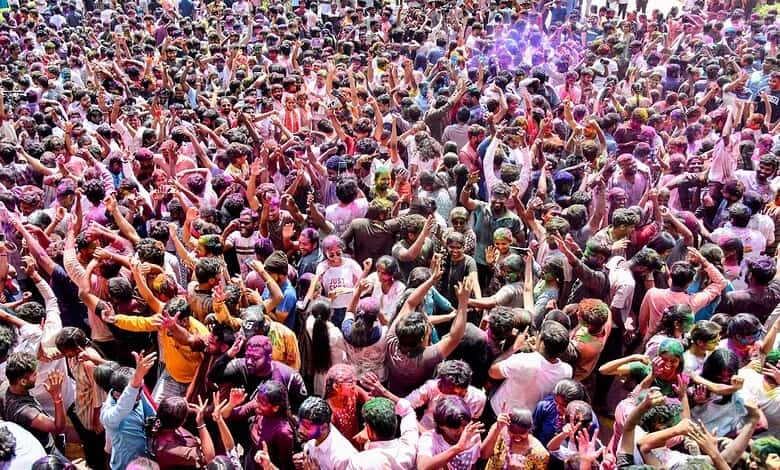People celebrating Holi in Telangana with colourful powders and festive spirit.