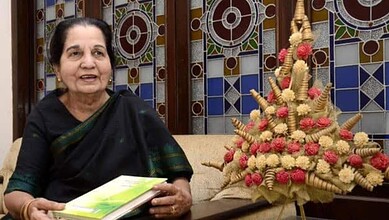 Portrait of Jeelani Bano, renowned Urdu writer and matriarch, in her home with traditional decor and flor.
