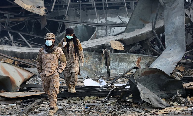Soldiers inspecting destruction after explosion in urban area.