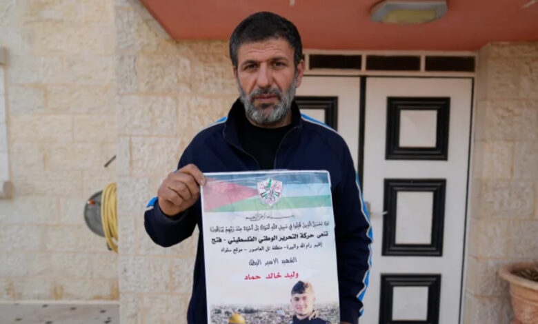 Khalid Ahmad holds a poster of his 17-year-old son, Walid Ahmad, who died in an Israeli prison, that read in Arabic, The hero prisoner Martyr, mercy and eternity for our righteous Martyrs.