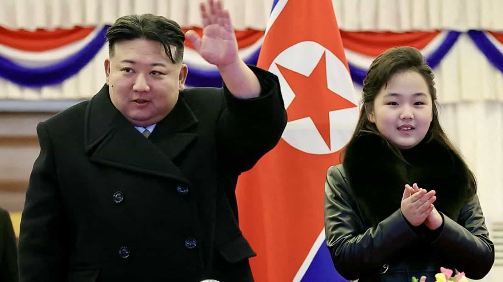 North Korean leader Kim Jong-un and his daughter attending a missile test event with North Korean flags i.