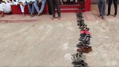 Queue of residents leaving footwear in line for LPG cylinders in Bhainsa.