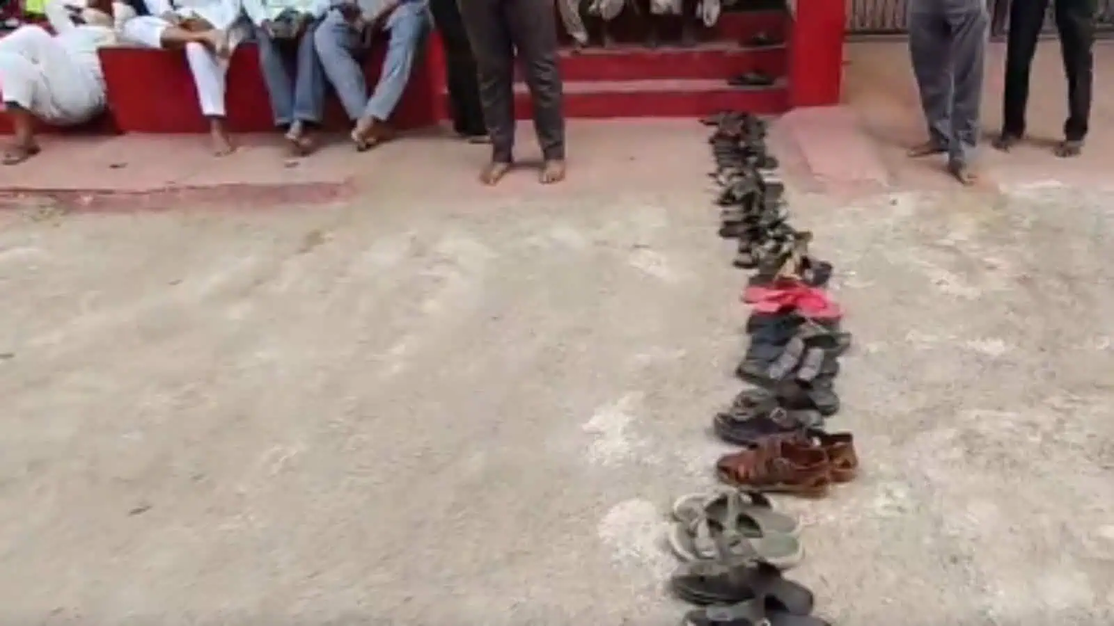 Queue of residents leaving footwear in line for LPG cylinders in Bhainsa, Telangana.