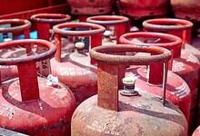 LPG cylinders stacked outdoors, used for cooking and energy supply in India.