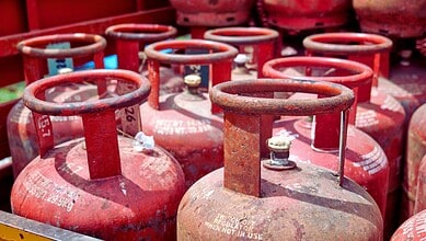 LPG cylinders stacked outdoors, used for cooking and energy supply in India.