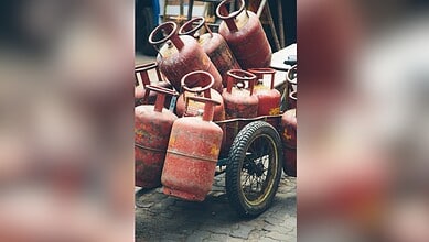 Collection of LPG cylinders on a cart, ready for distribution or storage.