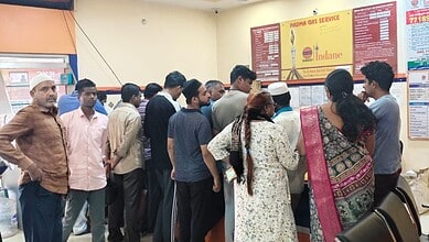 Crowd gathers at LPG booking counter amid rumours of shortage.