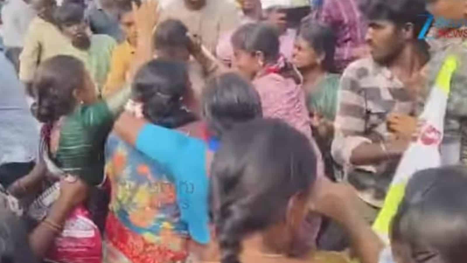 The image shows a lady constable being held by her hair by protesters at Khammam ZP Center on Monday, March 9.
