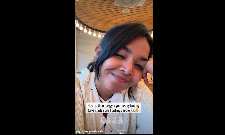 Indian student in Amsterdam smiling after finding lost house keys with stranger’s help.