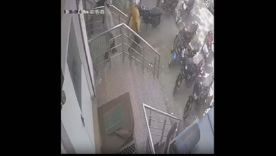 Security personnel and bystanders outside a building after a fatal incident involving a bank manager and.