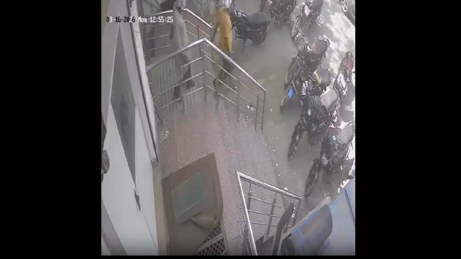 Security personnel and bystanders outside a building after a fatal incident involving a bank manager and.