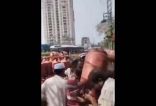 A gas agency staffer prevents a consumer from grabbing a cylinder in Hyderabad