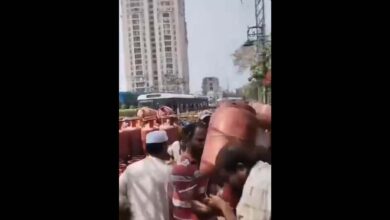 A gas agency staffer prevents a consumer from grabbing a cylinder in Hyderabad