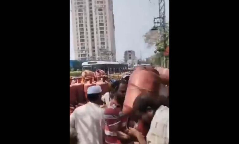 A gas agency staffer prevents a consumer from grabbing a cylinder in Hyderabad