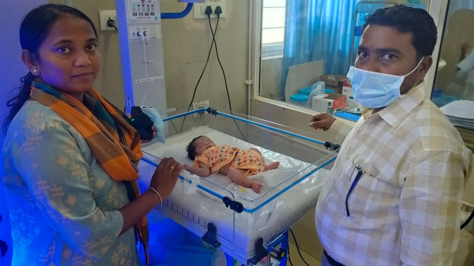 The image shows the officials, and the rescued newborn baby getting treated at the SNCU of Asifabad Government Hospital on Saturday, March 21, 2026.