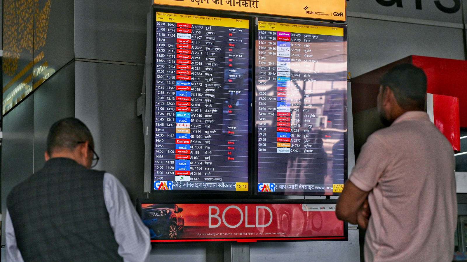 Passengers look at the display board for information amid the ongoing conflict in the Middle East, at Indira Gandhi International Airport, in New Delhi, Tuesday, March 3, 2026. (Source PTI)