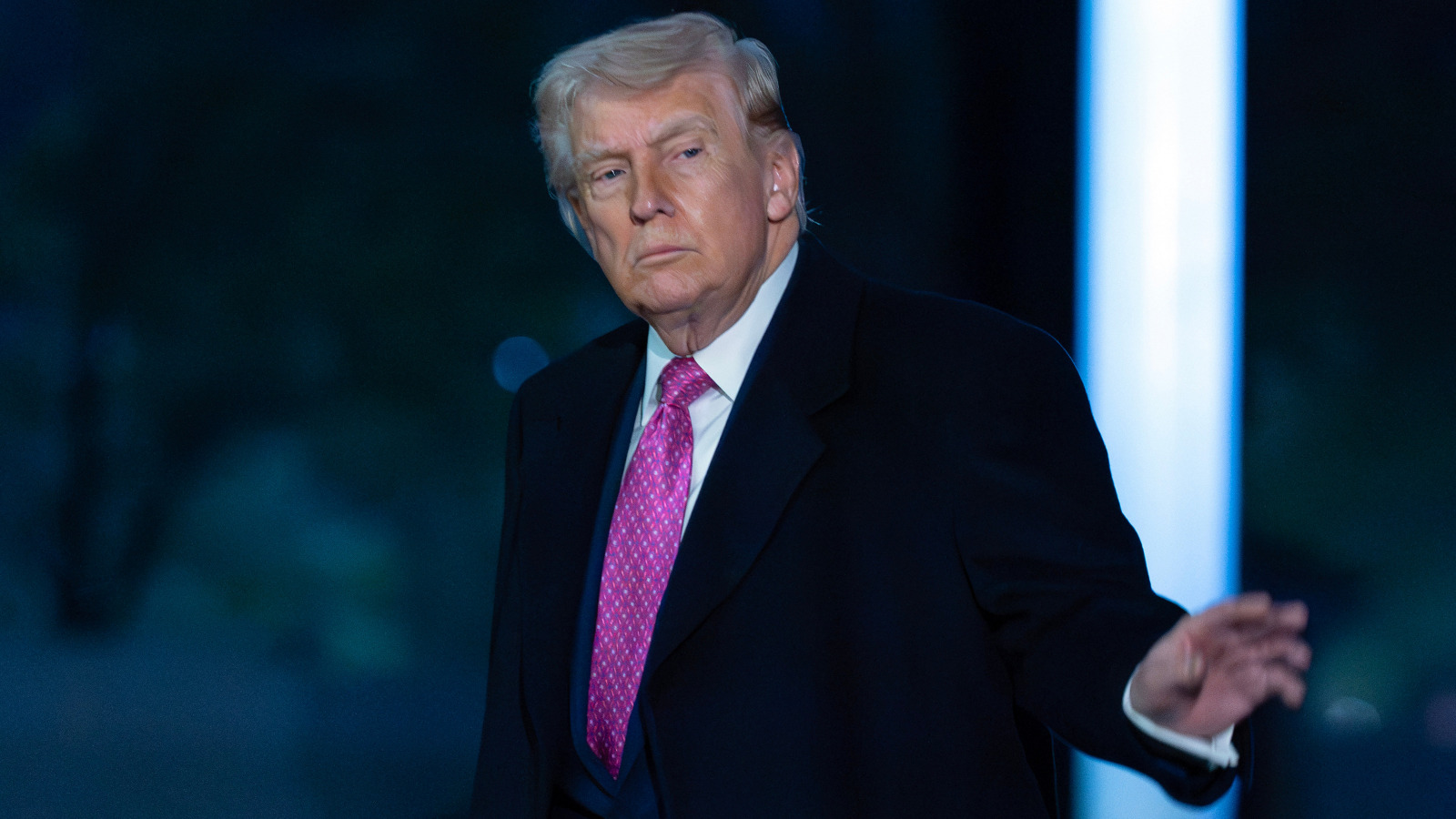 President Donald Trump waves to the media as he walks on the South Lawn upon his arrival to the White House.