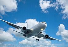 Commercial airplane flying in clear sky, promoting mystery flights for Palestinians to South Africa.